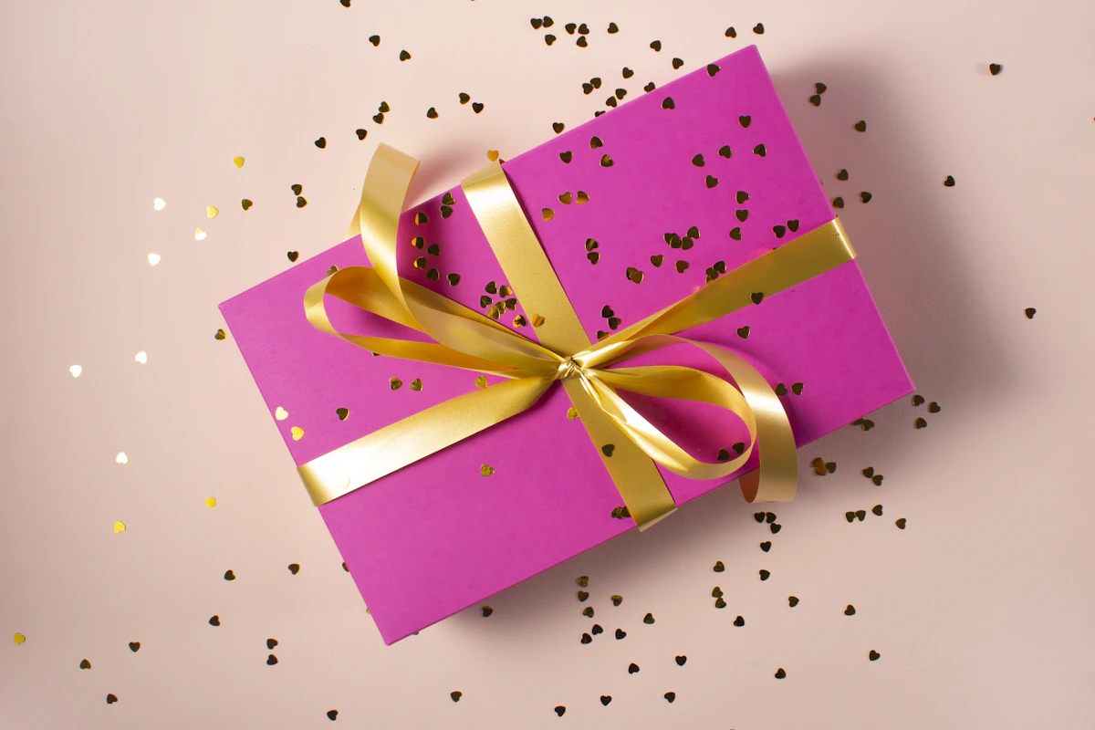 Pink wrapped gift tied with a yellow ribbon